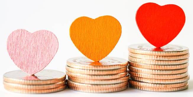 Stacks of coins with hearts on top